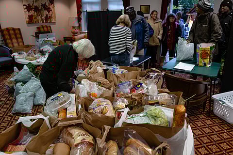 A customer walks into a bakery as a SNAP EBT information sign is displayed at the front door in Chicago, Sunday, Nov. 2, 2025.