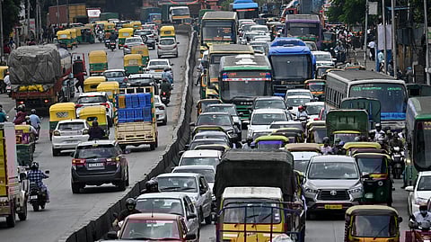 Slow moving traffic at toll gate junction.