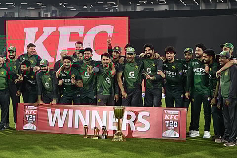 Pakistan's cricketers pose with the winning trophy at the end of third and final Twenty20 international cricket match between Pakistan and South Africa at the Gaddafi Stadium in Lahore on November 1, 2025.