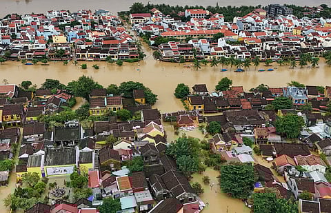 This aerial picture shows floodwaters inundating streets and buildings following heavy rains in Hoi An on October 30, 2025.
