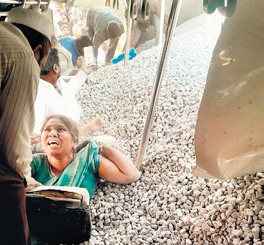 People rescue a teacher trapped in the pile of rubble at Mirzaguda.