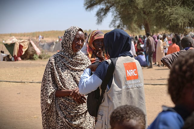 This photo, released by the Norwegian Refugee Council (NRC), shows a woman talking with an aid worker at a displacement camp where residents from el-Fasher sought refuge from fighting between government forces and the RSF in Tawila, Darfur region, Sudan, Monday, Nov. 3, 2025. 