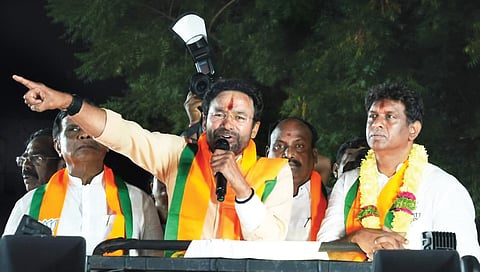 Union Minister G Kishan Reddy addresses an election rally as party candidate Lankala Deepak Reddy looks on, at Vengal Rao Nagar in Hyderabad on Tuesday.
