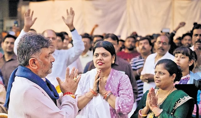 Deputy Chief Minister DK Shivakumar interacts with people from Bihar residing in Bengaluru on Sunday ahead of the Assembly polls in that state. 