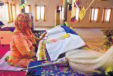 Sharanjit Kaur reads the Guru Granth Sahib as part of Akhand Path ahead of Guru Nanak Janyanti