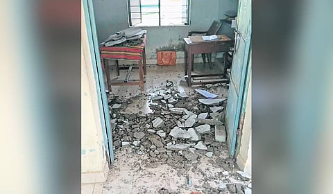 Debris of the ceiling plaster scattered on the floor of the VAO office in Neivasal Thenpathi village.