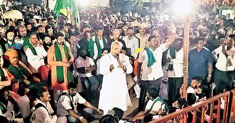 Sugar Minister Shivanand Patil addresses sugarcane farmers protesting in Gurlapur, Belagavi district, on Thursday.