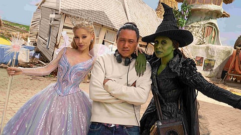 From L to R: Ariana Grande, Jon M Chu, and Cynthia Erivo