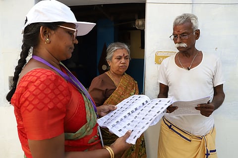 A BLO verifies voter details during the SIR of electoral rolls launched by the ECI in Coimbatore. Representative Image.