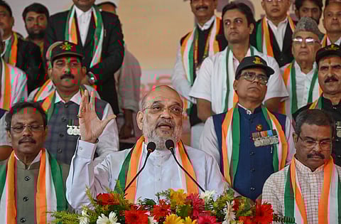 Union Home Minister Amit Shah addresses the gathering during an event marking 150 years of the national song 'Vande Mataram', in Patna, Friday, Nov. 7, 2025. Union Education Minister Dharmendra Pradhan and BJP leader Vinod Tawde are also seen. 