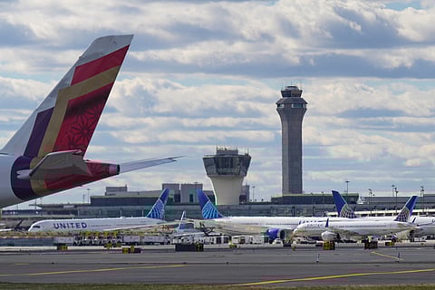 People wait in line at a Transportation Security Administration (TSA) security checkpoint at LaGuardia Airport in the Queens borough of New York, Sunday, Nov 9, 2025.