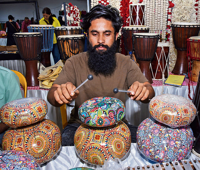 An artisan plays the 'happy drum'