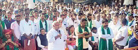 Sugar Minister Shivanand Patil addresses the sugarcane farmers at the protest site in Gurlapur, Belagavi district, on Saturday 