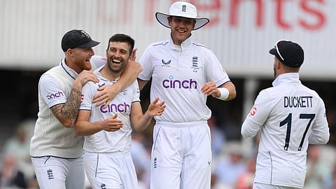 England's Mark Wood (2L) celebrates with his teammates after taking the wicket of Australia's Mitchell Starc on day two of the fifth Ashes cricket Test match between England and Australia at The Oval cricket ground in London on July 28, 2023. 