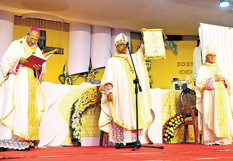 Cardinal Sebastian Francis displays the declaration issued by Pope Leo XIV elevating Mother Eliswa to the rank of blessed at Vallarpadam Basilica on Saturday. Archbishops Dr Joseph Kalathiparambil and Leopoldo Girelli are also seen 