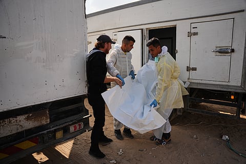 Bodies of unidentified Palestinians returned from Israel as part of the ceasefire deal are brought to Nasser Hospital in Khan Younis, Gaza Strip, Friday, Nov. 14, 2025.