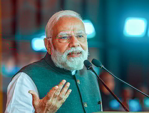 In this image released on Nov. 8, 2025, Prime Minister Narendra Modi addresses the gathering during the flagging off of Vande Bharat Express trains at the railway station, in Varanasi.