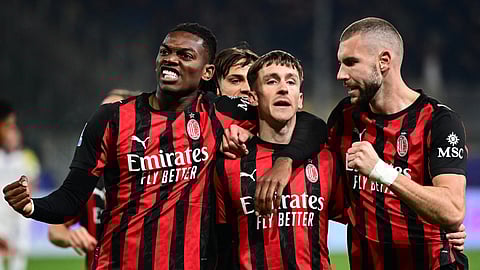 AC Milan's Alexis Saelemaekers (C) celebrates after scoring his team first goal with Strahinja Pavlovic (R) and Rafael Leao (L) during the Italian Serie A football match between Parma and AC Milan on November 8, 2025.