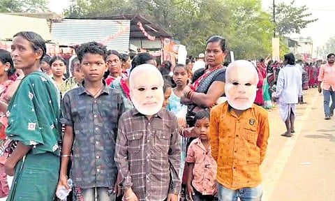 Supporters wearing masks of PM Narendra Modi during a BJP rally in Nuapada.