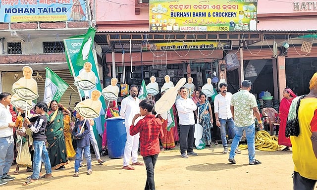Participants of a BJD rally stand near roadside shops in Nuapada.