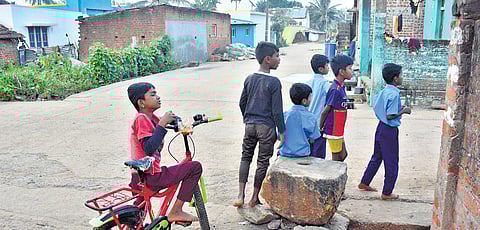 Children come out of their homes into a deserted Hale Heggudilu, following the death of Danda Nayaka 