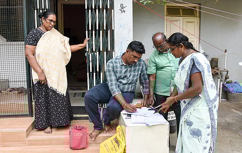 Official collecting details in Special Intensive revision form from voters door-to-door in Tiruchy on Tuesday