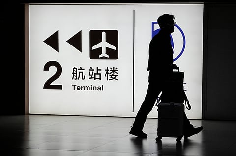 A passenger arrives at the Capital Airport in Beijing (Photo | AP)