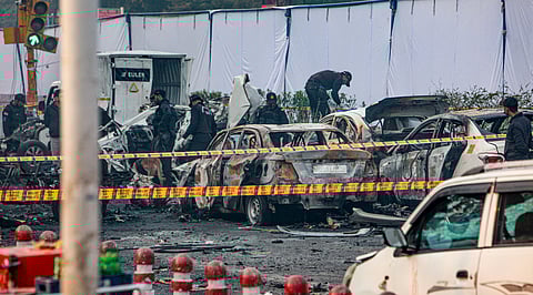 Charred remains of vehicles at a cordoned off area following a blast that occurred near Red Fort Metro Station on Monday, killing at least nine people and gutting several vehicles, in New Delhi, Tuesday, Nov. 11, 2025