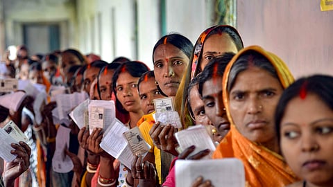 Voters show their ID cards at a polling station during the second and final phase of the Bihar Assembly elections, in Jehanabad, Tuesday, Nov. 11, 2025.