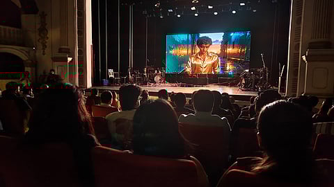 On the screen burned videos created by AI, but the modern AI stage was ironically clogged with ancient, beautiful, analogue instruments.