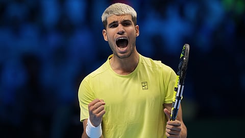 Spain's Carlos Alcaraz reacts after winning a point against United States' Taylor Fritz during their tennis match of the ATP World Tour Finals, in Turin, Italy, Tuesday, Nov. 11, 2025.