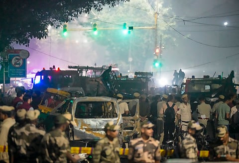 New Delhi: Security personnel at the spot after a blast occurred in a parked car near Red Fort, leaving multiple vehicles in flames, in New Delhi, Monday, Nov. 10, 2025. 