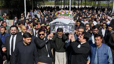 Mourners carry the coffin of lawyer Zubair Aslam Ghumman, who was killed in Tuesday's suicide bombing outside the gates of a district court, during a funeral prayer, in Islamabad, Pakistan, Wednesday, Nov. 12, 2025. 