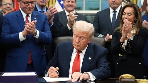 President Donald Trump signs the funding bill to reopen the government, in the Oval Office of the White House, Wednesday, Nov. 12, 2025, in Washington.