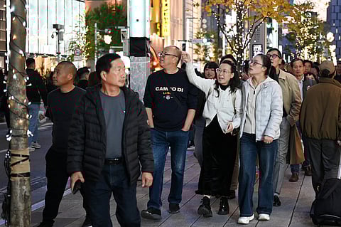 Chinese tourists walk in the Ginza shopping district in Tokyo (Photo | AFP)