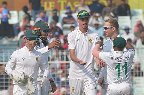 Simon Harmer celebrates with teammates after taking the wicket of India's Axar Patel on day two of the first Test cricket match of a series between India and South Africa, at the Eden Gardens, in Kolkata, Saturday, Nov. 15, 2025.