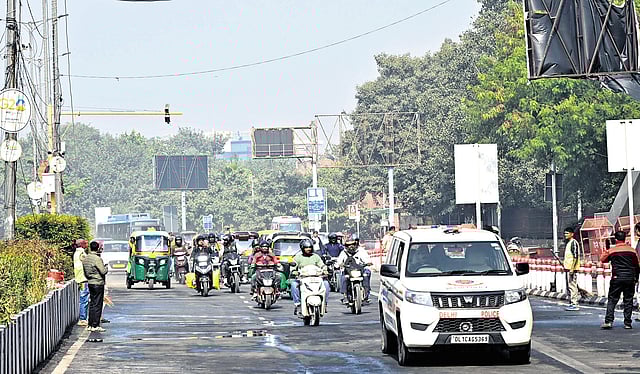 People commute on Netaji Subhash Marg following its reopening on Saturday.