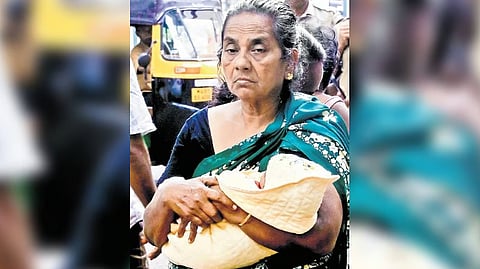 Moly, mother-in-law of Sivapriya, with the newborn baby during the protest outside the SAT Hospital on Sunday.