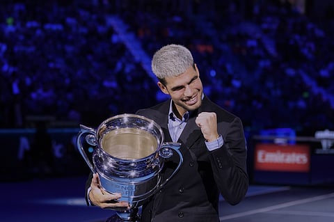 Italy's Jannik Sinner lifts the trophy after winning over Spain's Carlos Alcaraz at the end of the men's single final match at the ATP Finals tennis tournament, in Turin, on November 16, 2025.