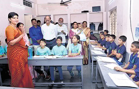 A file photo of District Collector Dasari Hari Chandana interacting with students seated in a U-shaped layout in Hyderabad.