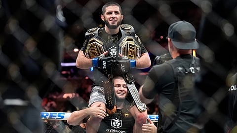 Russia's Islam Makhachev celebrates after defeating Australia's Jack Della Maddalena during a welterweight title bout at the UFC 322 mixed martial arts event, Saturday, Nov. 15, 2025, in New York. 