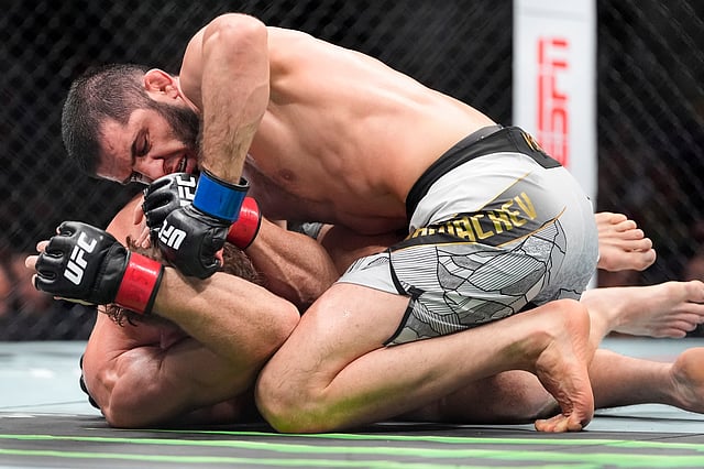 Australia's Jack Della Maddalena grapples with Russia's Islam Makhachev during the first round of a welterweight title bout at the UFC 322 mixed martial arts event, Saturday, Nov. 15, 2025, in New York. 