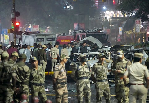Security personnel at the spot after a blast occurred in a parked car near Red Fort, leaving multiple vehicles in flames, in New Delhi, Monday, Nov. 10, 2025.