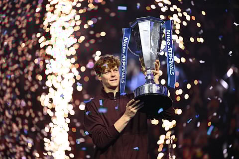 Italy's Jannik Sinner lifts the trophy after winning over Spain's Carlos Alcaraz at the end of the men's single final match at the ATP Finals tennis tournament, in Turin, on November 16, 2025.