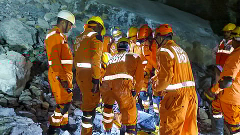 NDRF personnel conduct a rescue operation after a portion of a stone quarry collapsed in Sonbhadra.