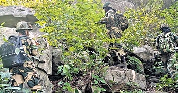 Security personnel engaged in combing operation in the forested terrain 