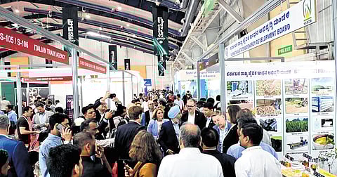 Delegates and visitors throng various exhibition stalls during the inaugural of the Bengaluru Tech Summit on Tuesday