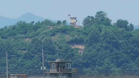 FILE - A North Korean military guard post, top, and a South Korean post, bottom, are seen from Paju, South Korea, near the border with North Korea, on June 18, 2024