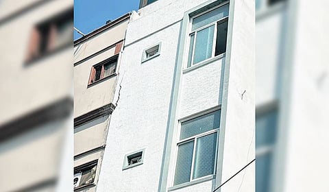 The building that developed cracks after deep cellar excavation at an adjoining construction site on Monday. 