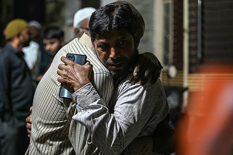 Family members and relatives of victims, who were killed in a bus accident near the holy city of Medina, mourn in Hyderabad on November 17, 2025.